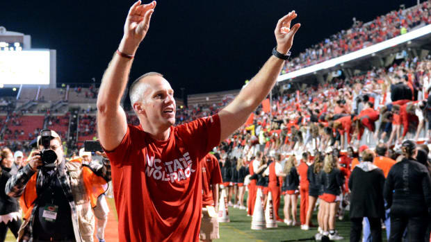Wolfpack coach Dave Doeren acknowledges the crowd during a night game at Carter-Finley Stadium